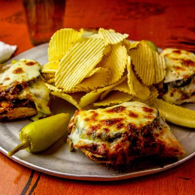 Veggie stromboli baked turnover, served with chips, peppers and pickle