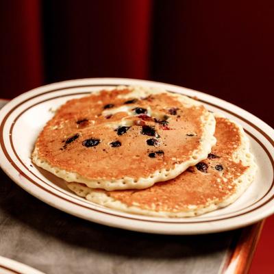 Two blueberry pancakes on a palte.