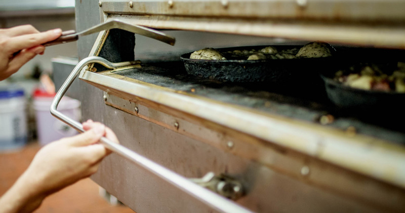 Staff working in the kitchen, serving guests