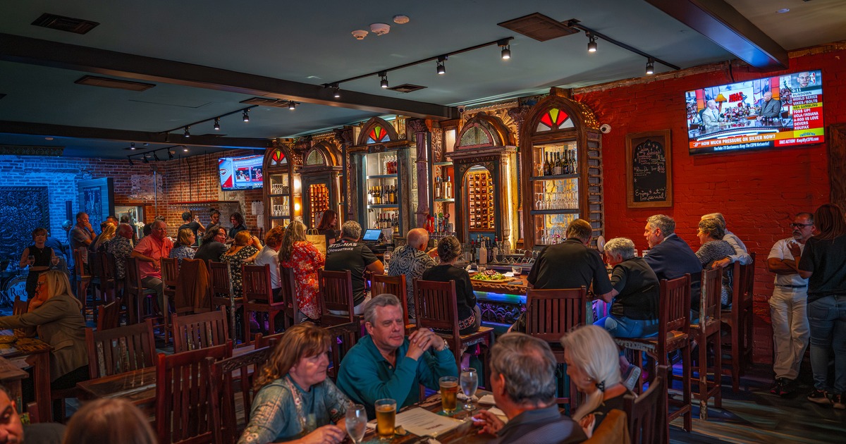 Interior space, bar and seating area full of guests