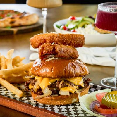 Bevo burger served with fries and onion rings.