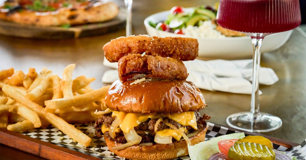 Cheeseburger paired with fries and onion rings