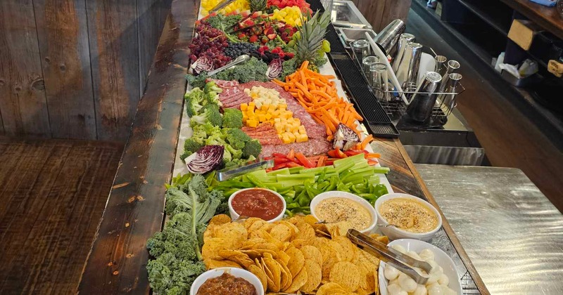 A large, elaborate charcuterie, snack, and fruit board