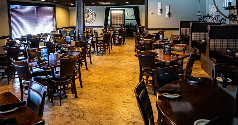 Interior, spacious seating area with chairs, tables and dining booths