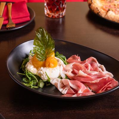 Burrata cheese, prosciutto, cherry tomatoes, basil, and olive oil.