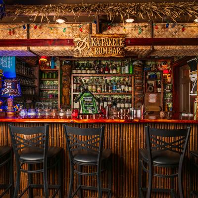Interior, front view of tiki bar and bar chairs.