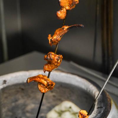 Chicken Tikka being prepared in a traditional tandoor oven.