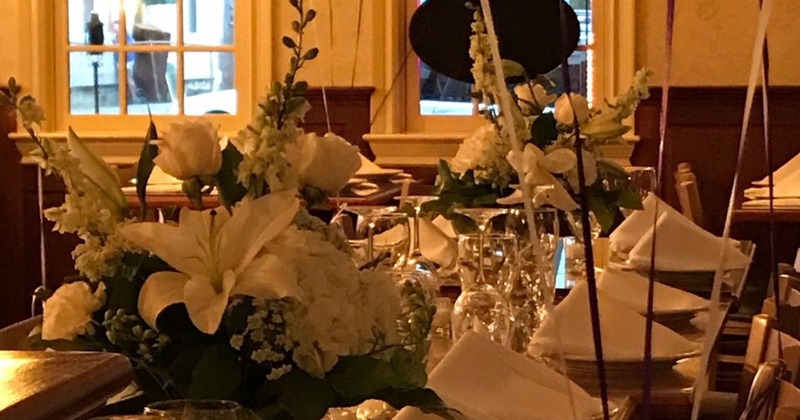 Decorated dining table with flowers, napkins, glasses and plates