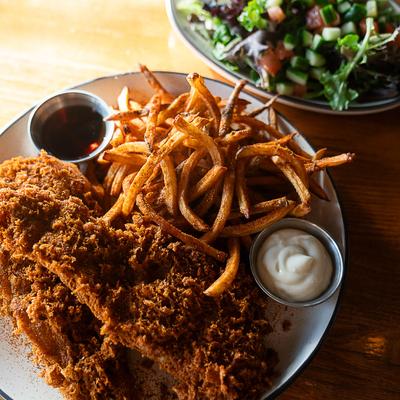 Fish and chips and a side of spring mixed salad.