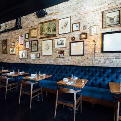 Banquette seating with set tables, wall art