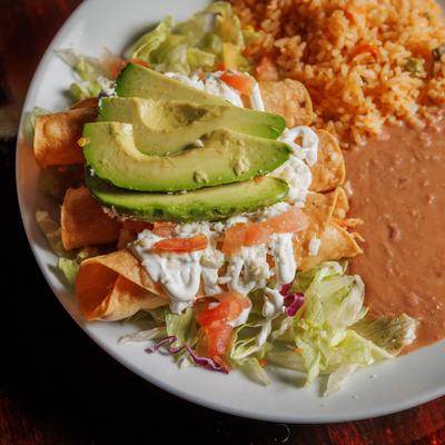 Chicken filled flautas served with lettuce, tomato, cheese, avocado, rice, beans and sour cream