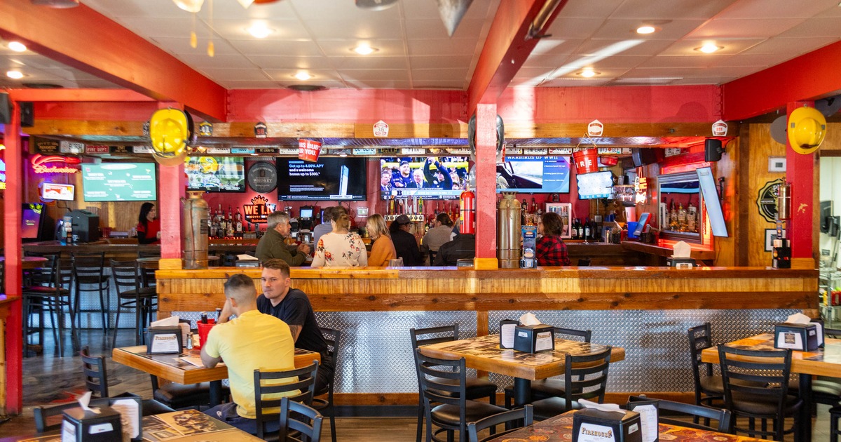 Dining room with tables, chairs and a view of the bar counter