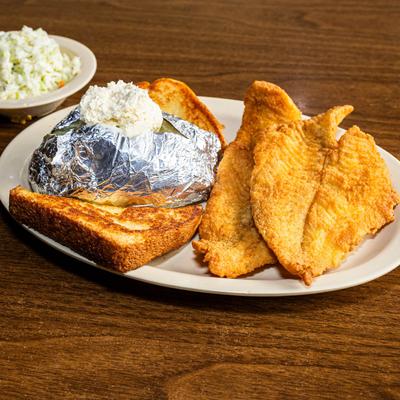 Fried flounder served with a baked potato, toasted bread, and coleslaw.