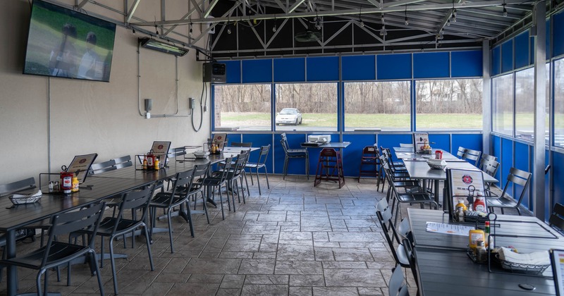 Outdoor, covered patio with tables and chairs
