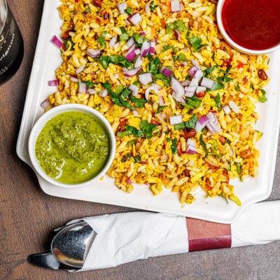 Puffed rice with vegetables and chutney sauces.