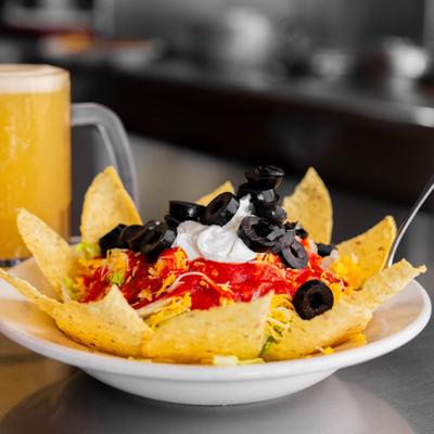 Taco salad served with a beer.