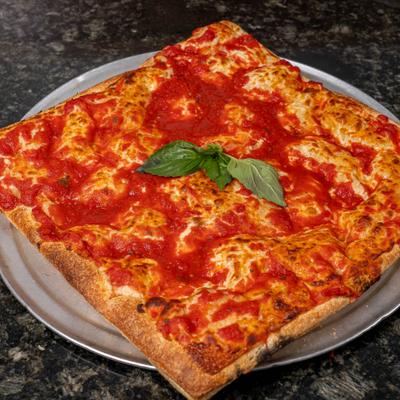 Square-cut Grandpa Sicilian pizza with tomato sauce and basil garnish.