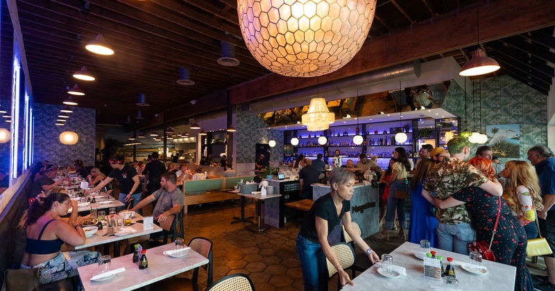 Diner area, table staff preparing, chandelier