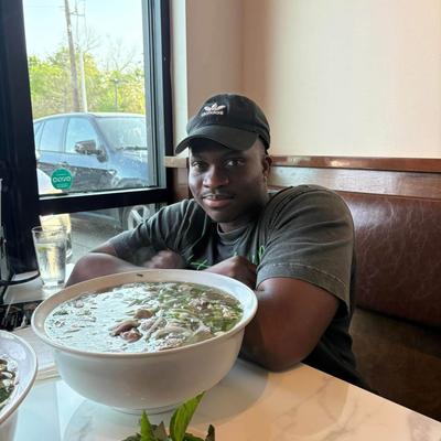 Customer posing with a large bowl of soup.