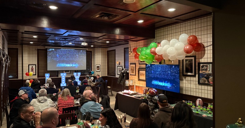 Sports viewing party with drinks and balloon decorations