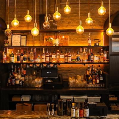 Bar area featuring exposed brick walls and Edison-bulb style pendant lighting.