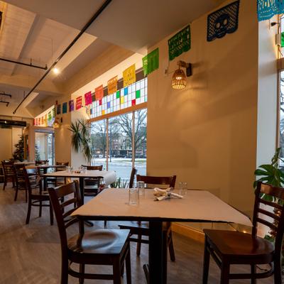 Interior with traditional banners, wooden tables and chairs.
