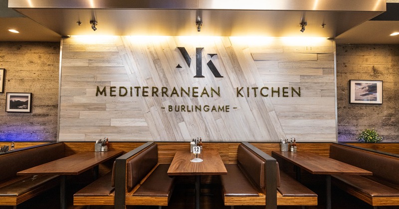 Interior of the restaurant, featuring booth seating and a wall with the restaurant's name