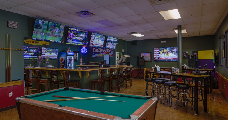 Inside, pool table, barstools, tables, bar, TVs on the walls