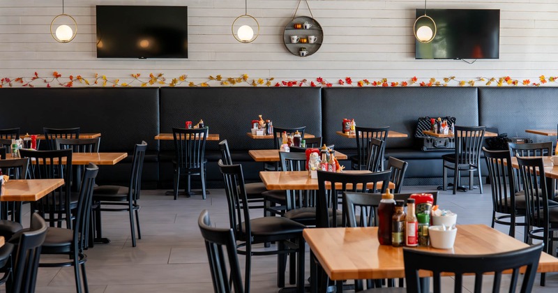 Interior, dining area, tables and seats, TVs on the wall