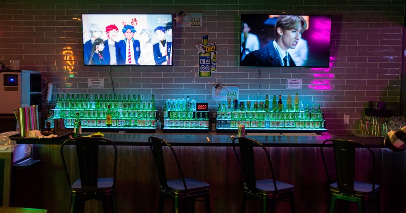 Bar area, bar stools, TVs on the walls