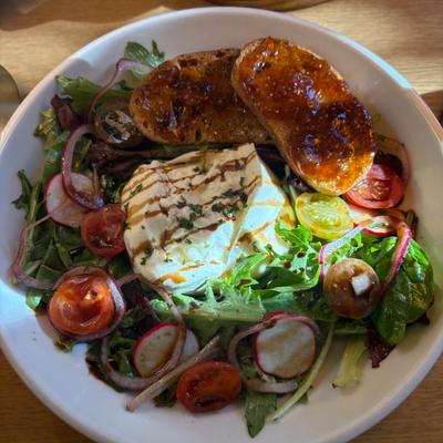 Burrata salad with mixed greens, tomatoes, and crostini with fig spread.