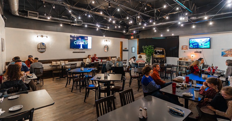 Interior space, dining area full of guests enjoying their food