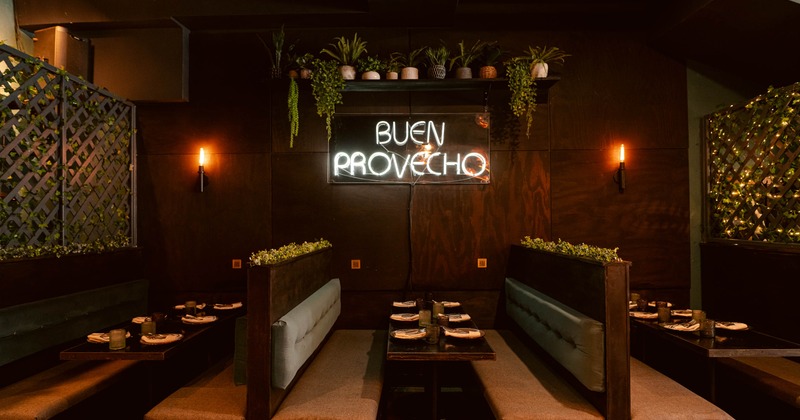 Interior view of a restaurant featuring booths with a neon sign