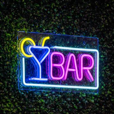 Colorful neon sign reading Bar with a cocktail glass graphic.