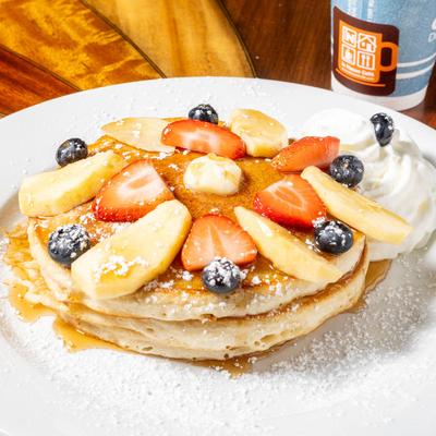 Pancakes with fruits and cream.