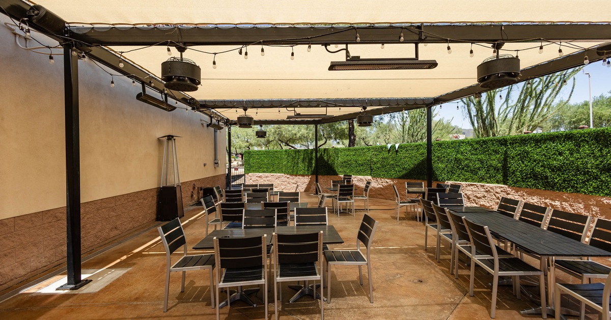 Outdoor, covered patio with tables and chairs