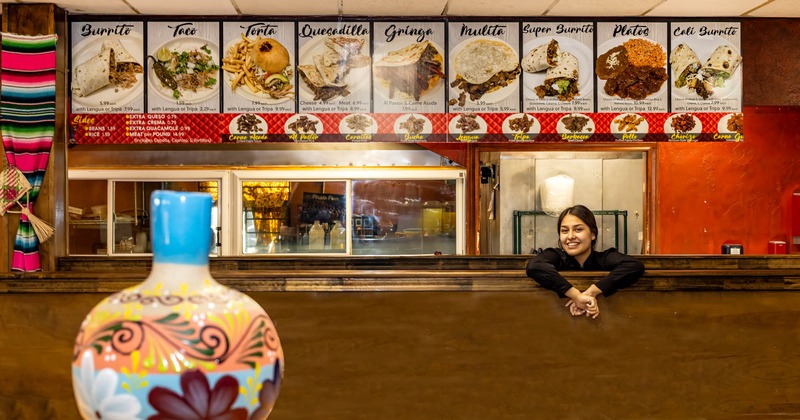 An employee at an order counter