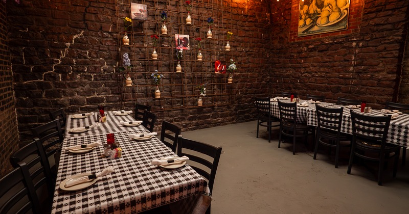 Nicely done and cozy private area with two large tables set for guests, perfect for any occasion