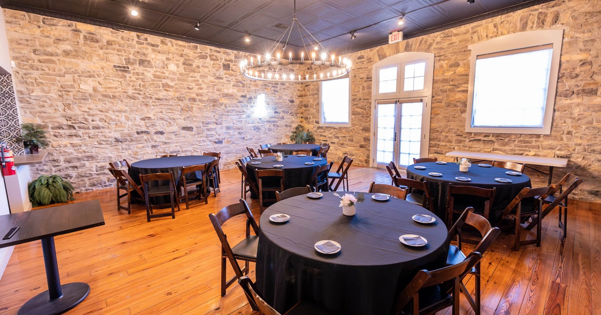 Interior, round tables with black tablecloths and chairs