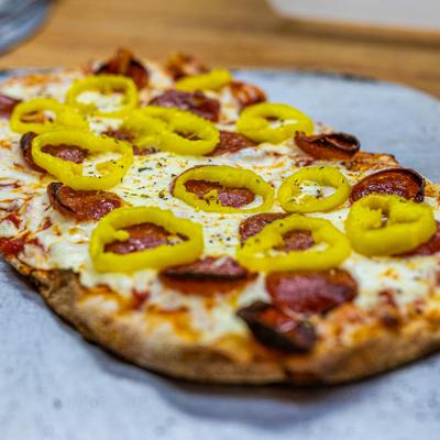 Mangia's Favorite artisan pizza with pizza sauce, mozzarella, banana peppers, and pepperoni.
