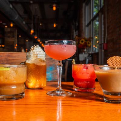 Colorful cocktails on a wooden table.