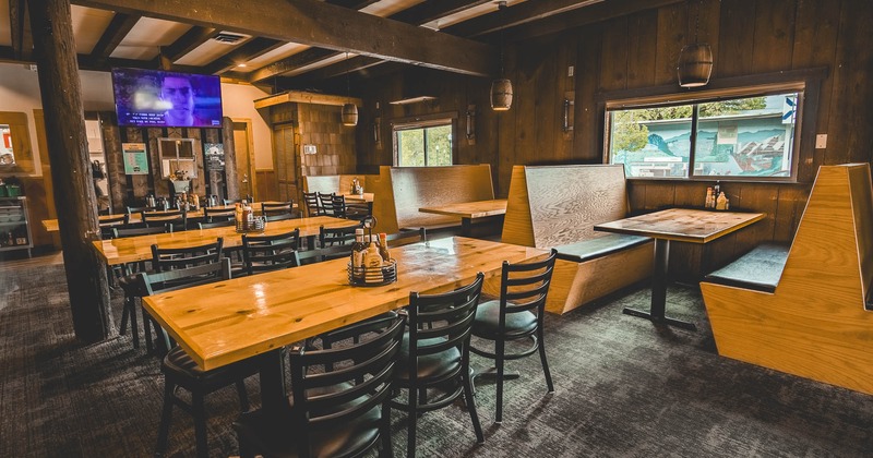Interior, dining area with tables and chairs near restaurant booths