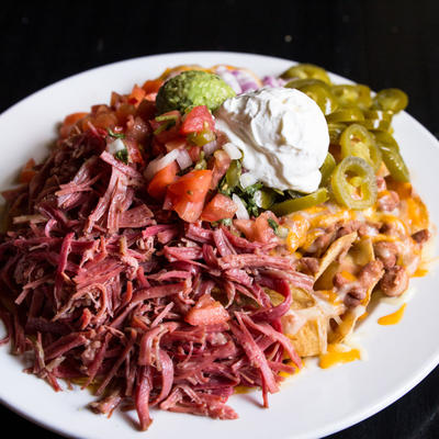 Irish Nachos. A heap of corned beef, tomatoes, red onion, jalapenos, sour cream, guacamole and pico de gallo