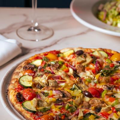 Close-up of a loaded vegetable pizza.