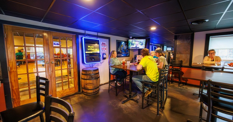 Interior, seating area with wooden tables and bar chairs