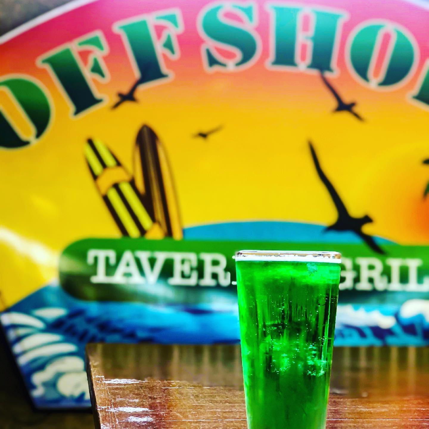 Green Beer in front of sign
