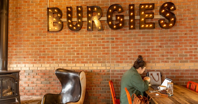 Interior, a chair near a stove, a guest sitting at a table