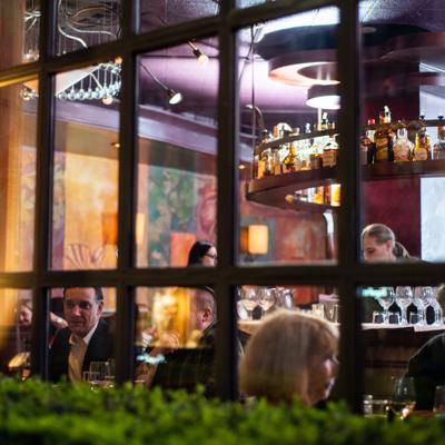 Exterior, view of the interior with guests through a window