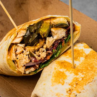 Grilled chicken wrap, with pepperjack cheese, chili mayo, bacon, tomato, and red onion.