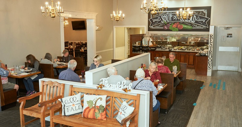 Interior, booths, tables, benches, display counter, chandeliers, customers eating